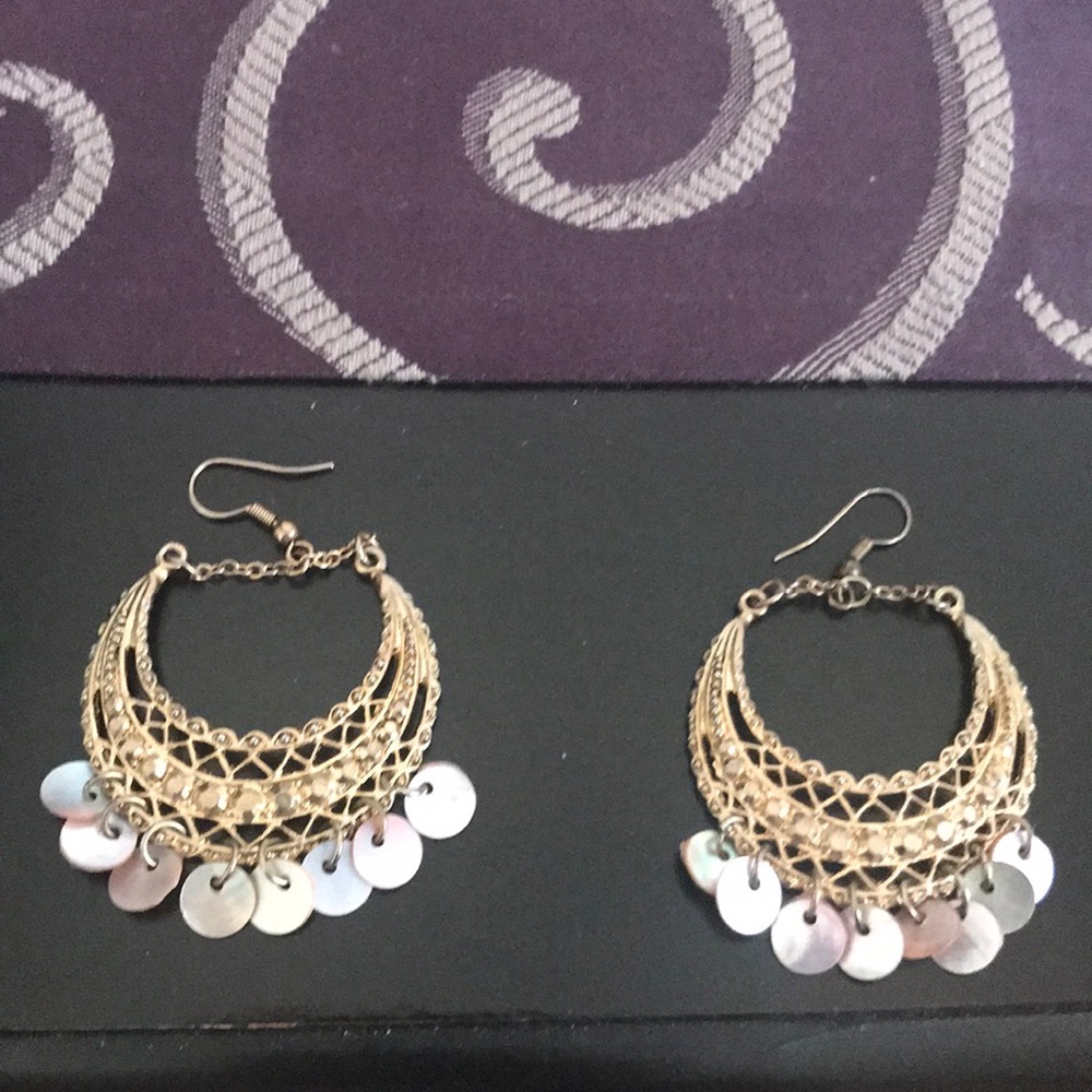Pair of gold hanging earrings with pink sequins.